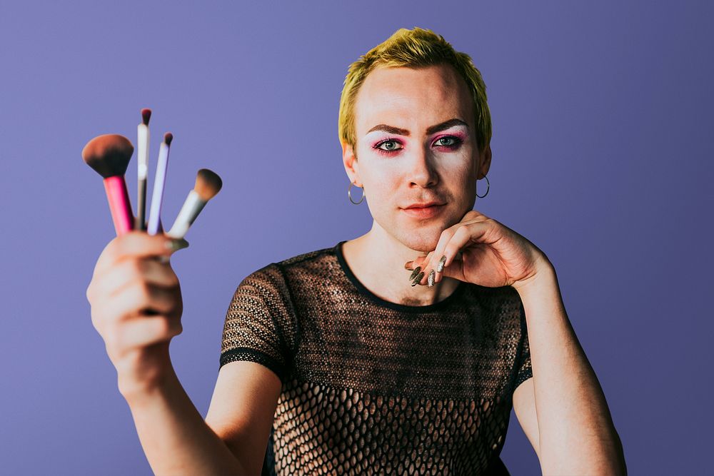 Non-binary beauty blogger with makeup tools