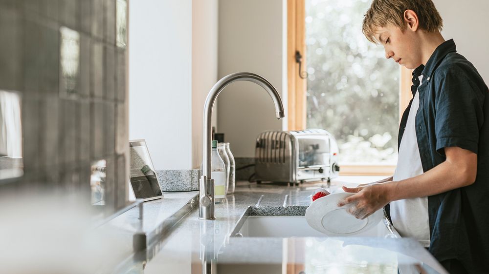 Boy washing dishes, basic house chores