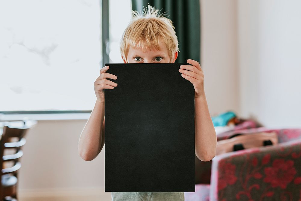 Boy holding blank black board