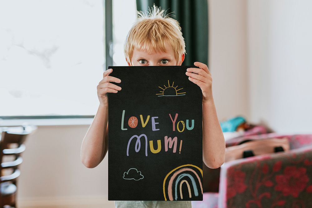 Boy holding blank black board, love you mum text
