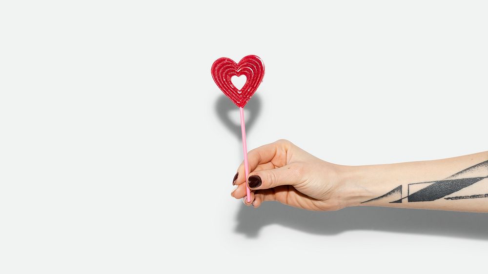 Valentine desktop wallpaper, love background, hand holding heart lollipop