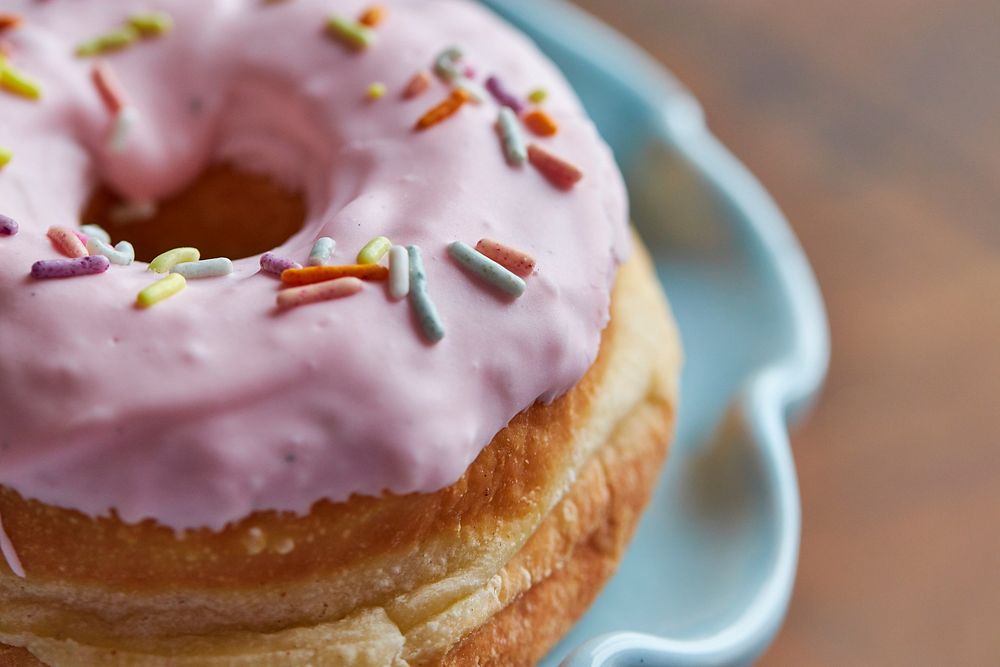 Free pink donut with sprinkles image, public domain dessert CC0 photo.