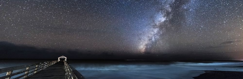 The Milky Way crossing the night sky at Waimea State Recreation Pier in Hawaii, USA