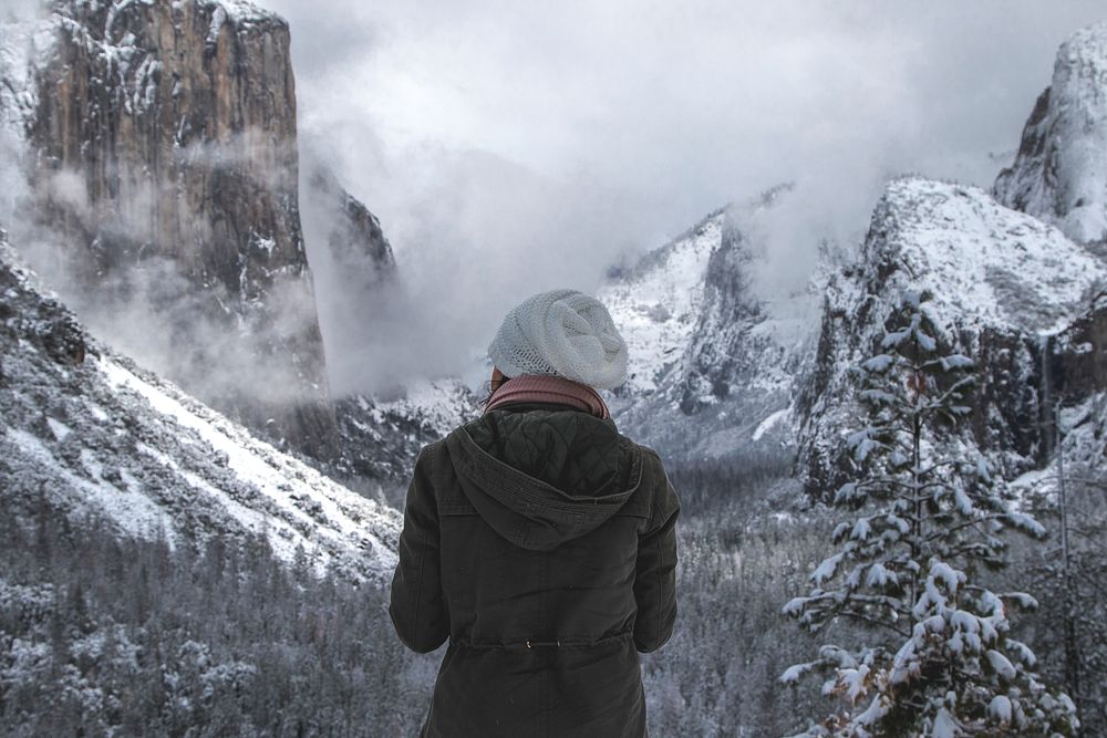 Woman looking at the mountain peaks in Yosemite Valley, USA