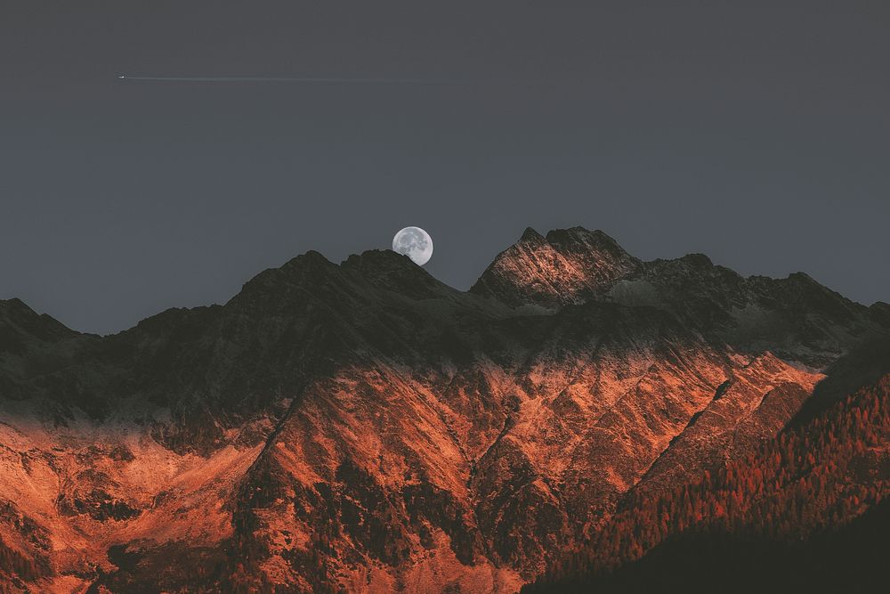 Moon above the M&uuml;hlwald commune in South Tyrol,  Italy