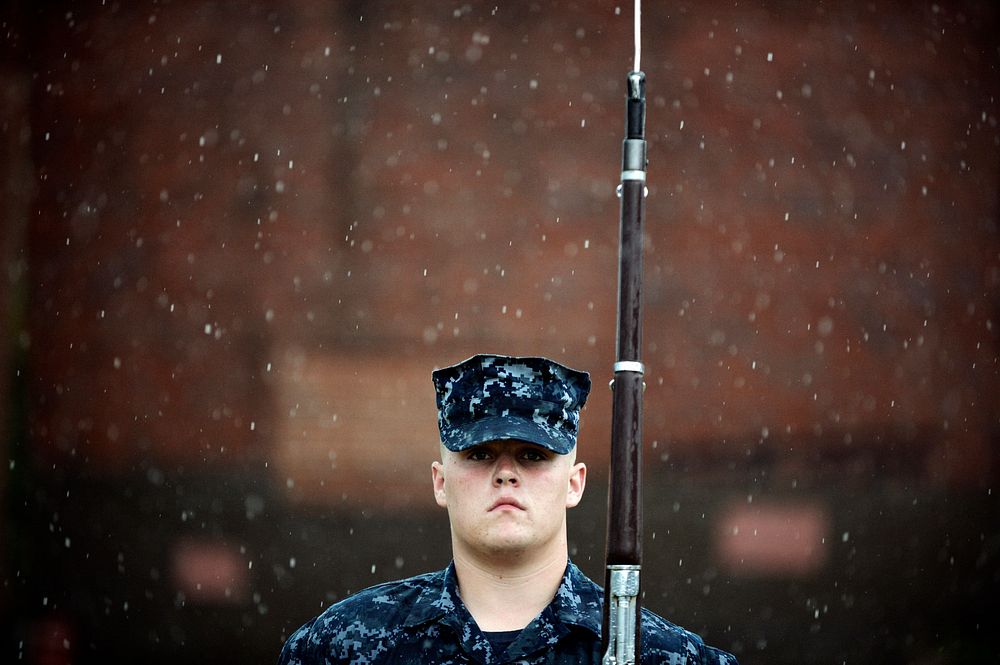 U.S. Navy Seaman Kenyon Crisp, a member of the U.S. Ceremonial Guard Drill Team, performs a left shoulder arms movement…
