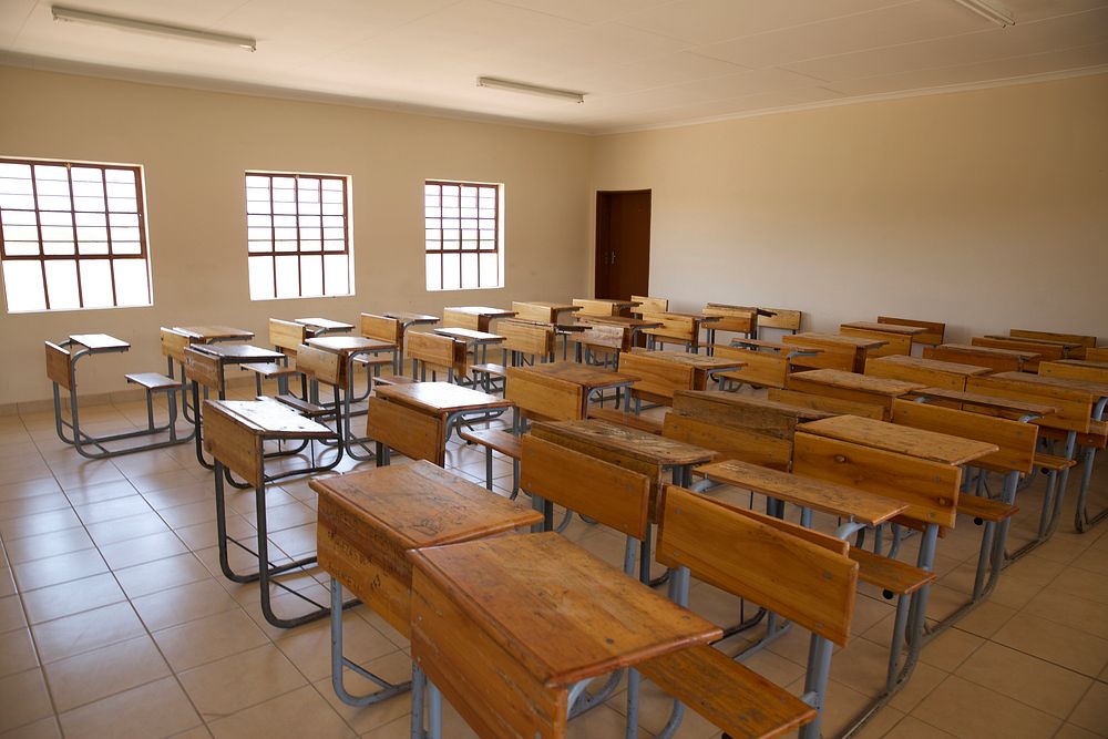 Wooden tables in a classroom. Original public domain image from Flickr