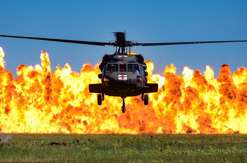 A UH-60 Black Hawk helicopters hovers while a wall of fire burns during the South Carolina National Guard Air and Ground…