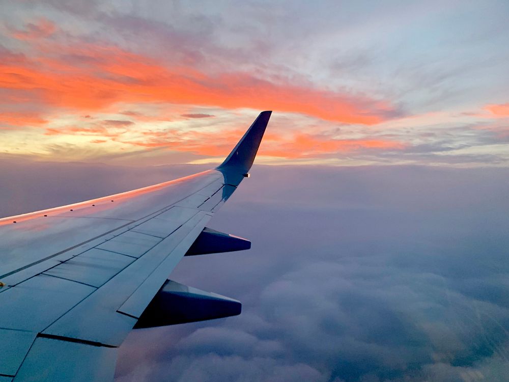 Beautiful sunset sky view from airplane window. Original public domain image from Flickr