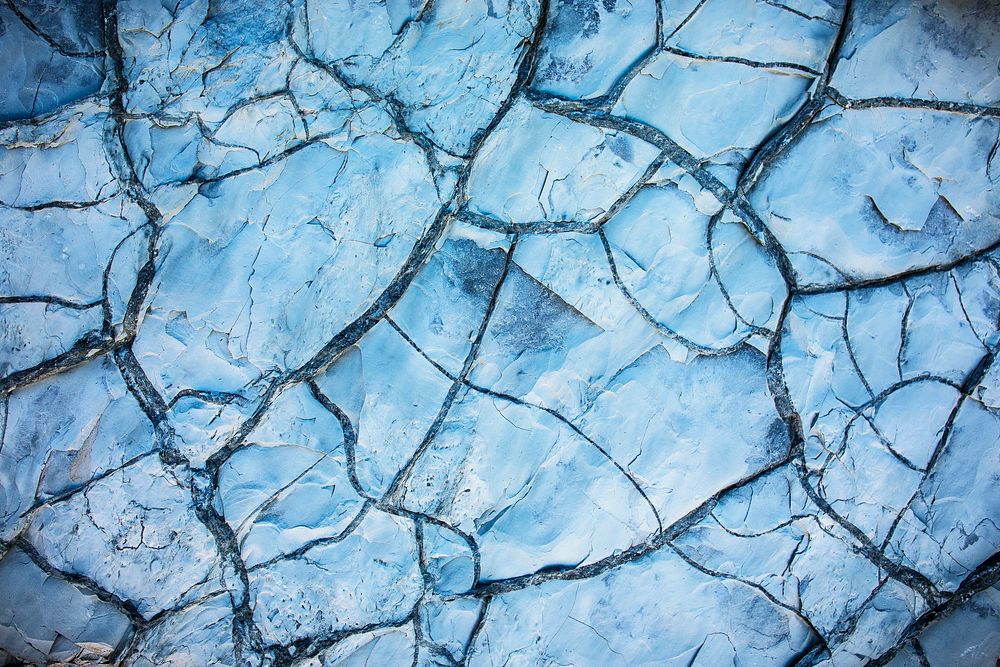 Blue cracked ground texture, abstract background