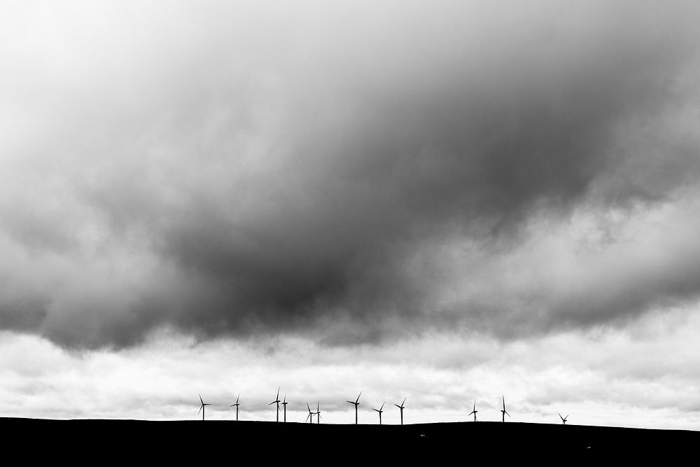Cloudy sky over wind farm, monotone. Original public domain image from Flickr