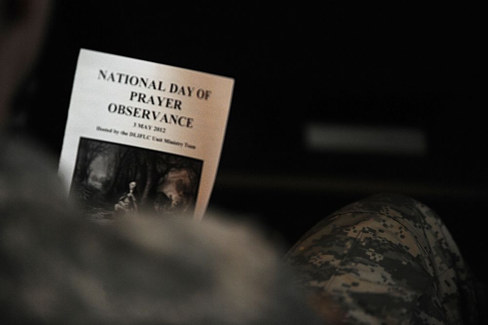 National Day of Prayer flyer in a soldier's hand. Original public domain image from Flickr