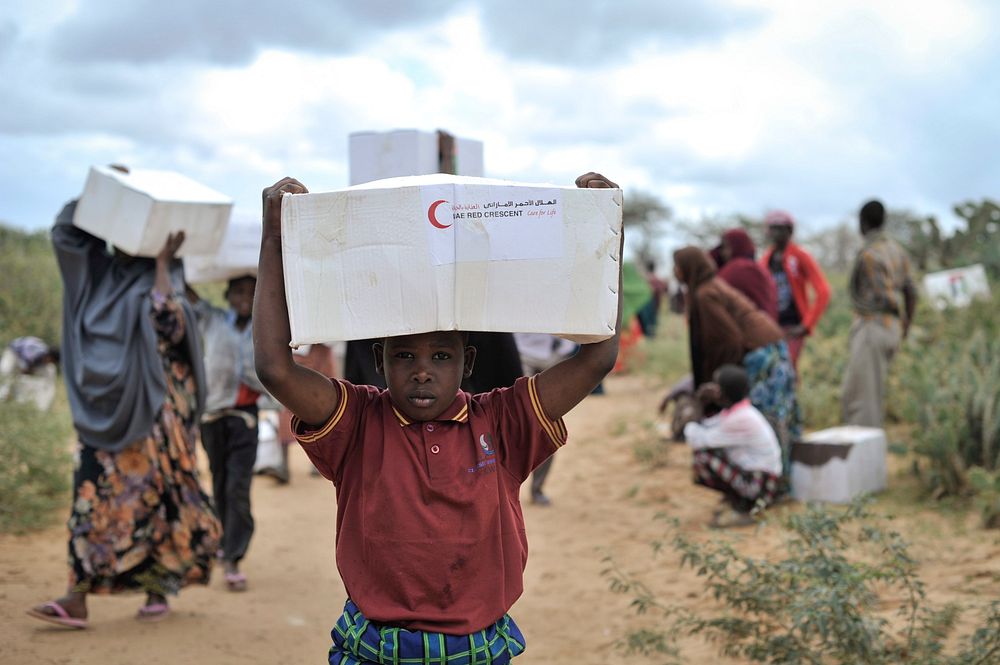 A young boy carries away a box of food from a food distribution center in Afgoye, Somalia, on August 4th.
