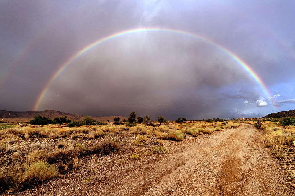 Rainbow across a dirt road near the settlement of Antares in northwestern Arizona. Original image from Carol M.…