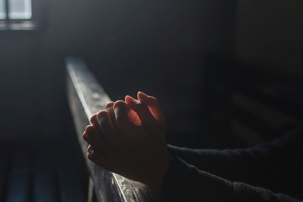 Free hands praying in church image, public domain people CC0 photo.
