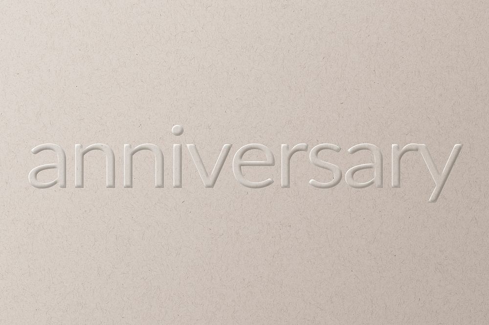 Anniversary embossed text on white paper background