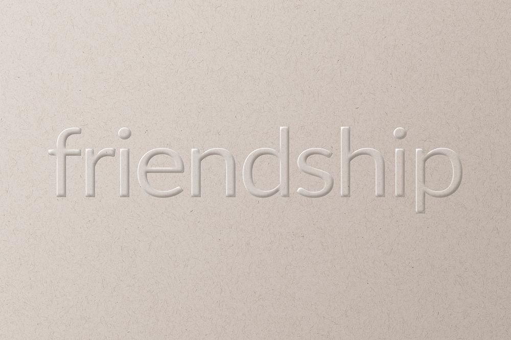 Friendship embossed text on white paper background