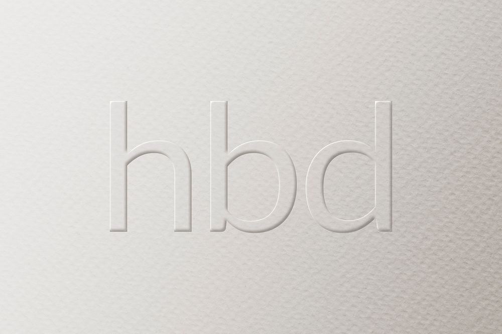 HBD embossed text white paper background