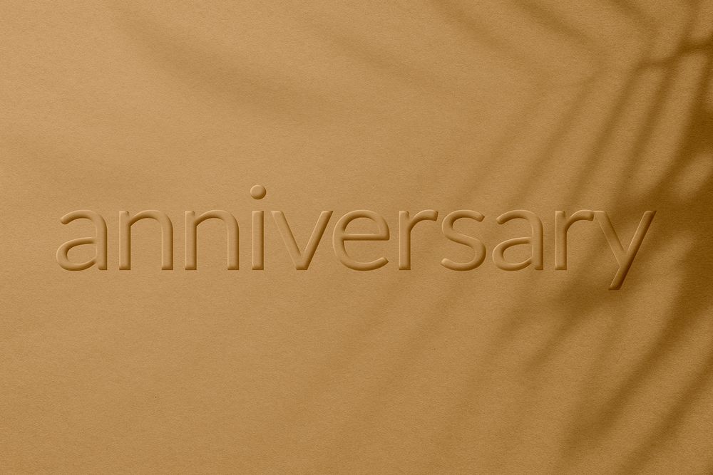 Anniversary word embossed concrete texture shadow plant