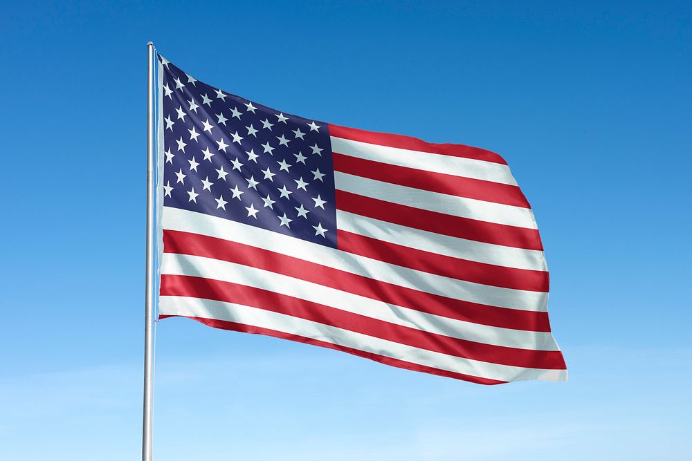 Waving United States, US flag, national symbol, blue sky