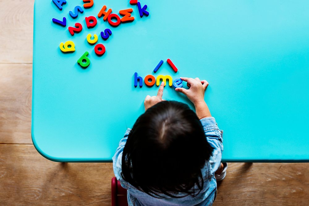 Kid playing with letters background
