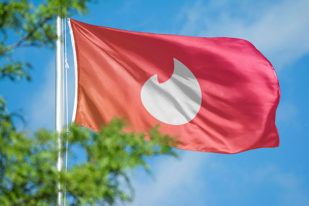 Tinder icon for social media on flag. 26 MAY 2022 - BANGKOK, THAILAND