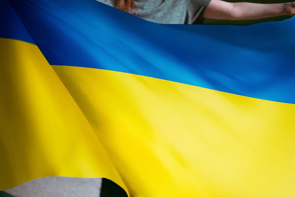 Person holding Ukraine flag background, national symbol