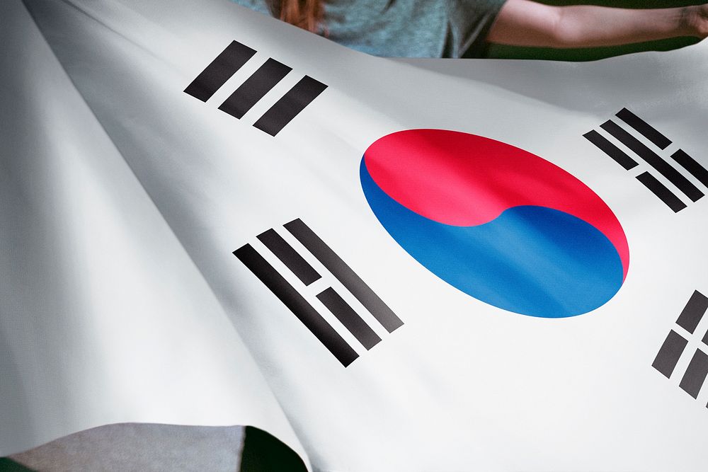 Person holding South Korean flag background, national symbol