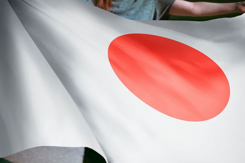 Person holding Japanese flag background, national symbol