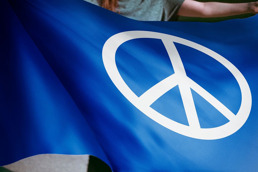 Person waving blue flag with peace sign, Campaign for Nuclear Disarmament
