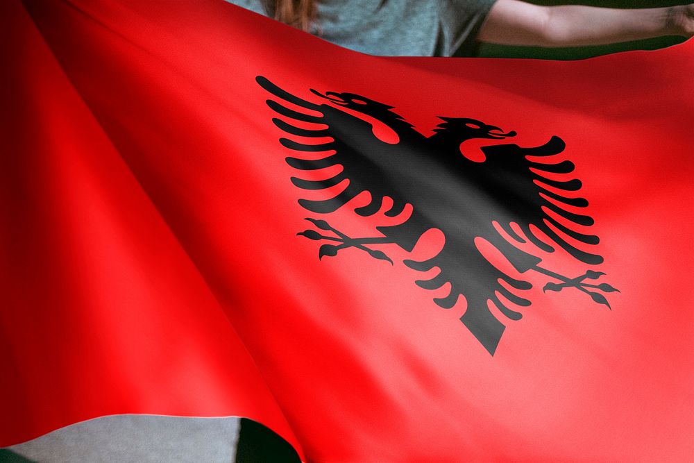 Person holding Albania flag background, national symbol