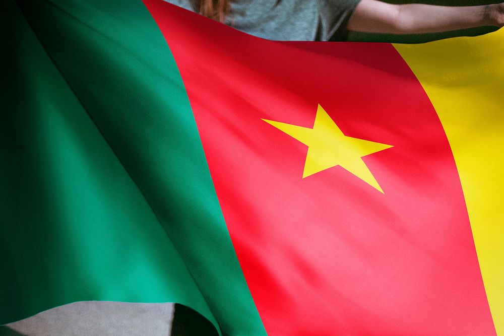 Person holding Cameroon flag background, national symbol