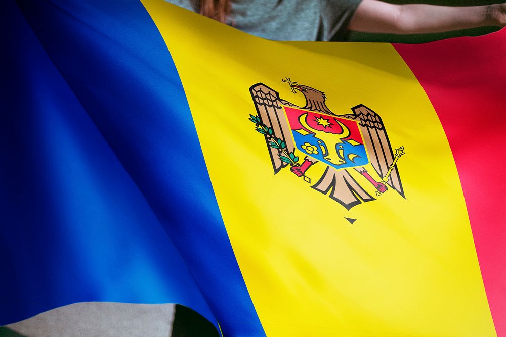 Person holding Moldova flag background, national symbol