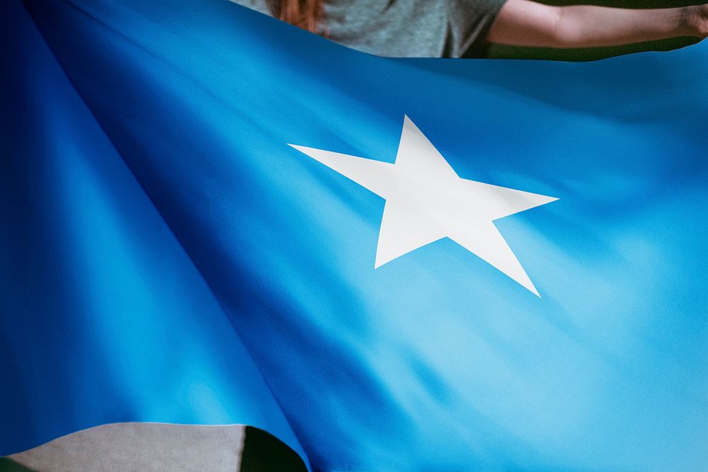 Person holding Somalia flag background, national symbol