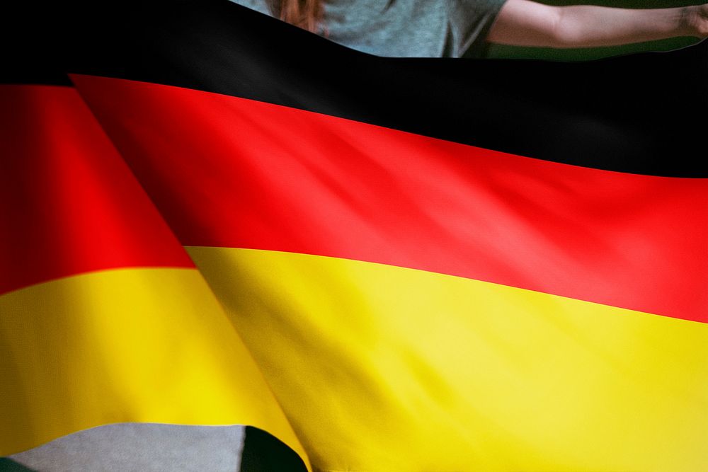 Person holding German flag background, national symbol