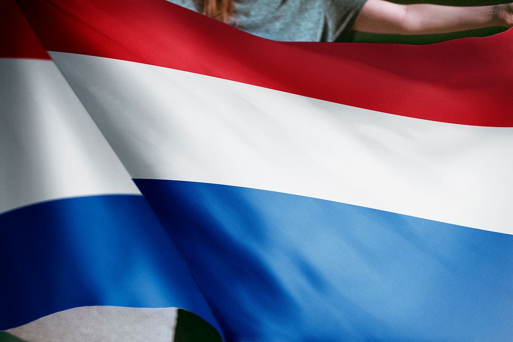 Person holding Netherlands flag background, national symbol