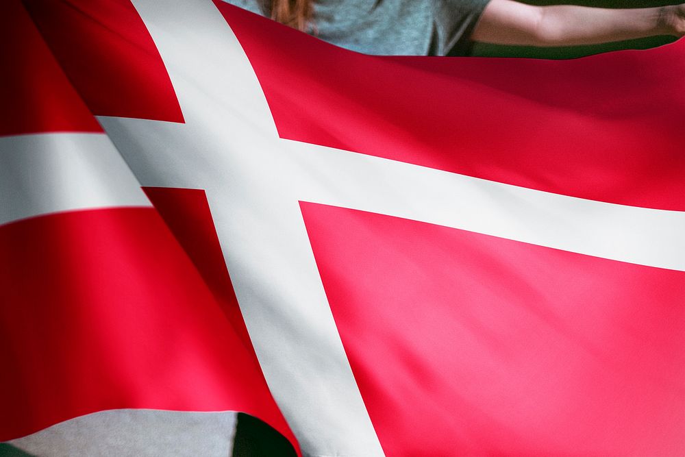Person holding Denmark flag background, national symbol
