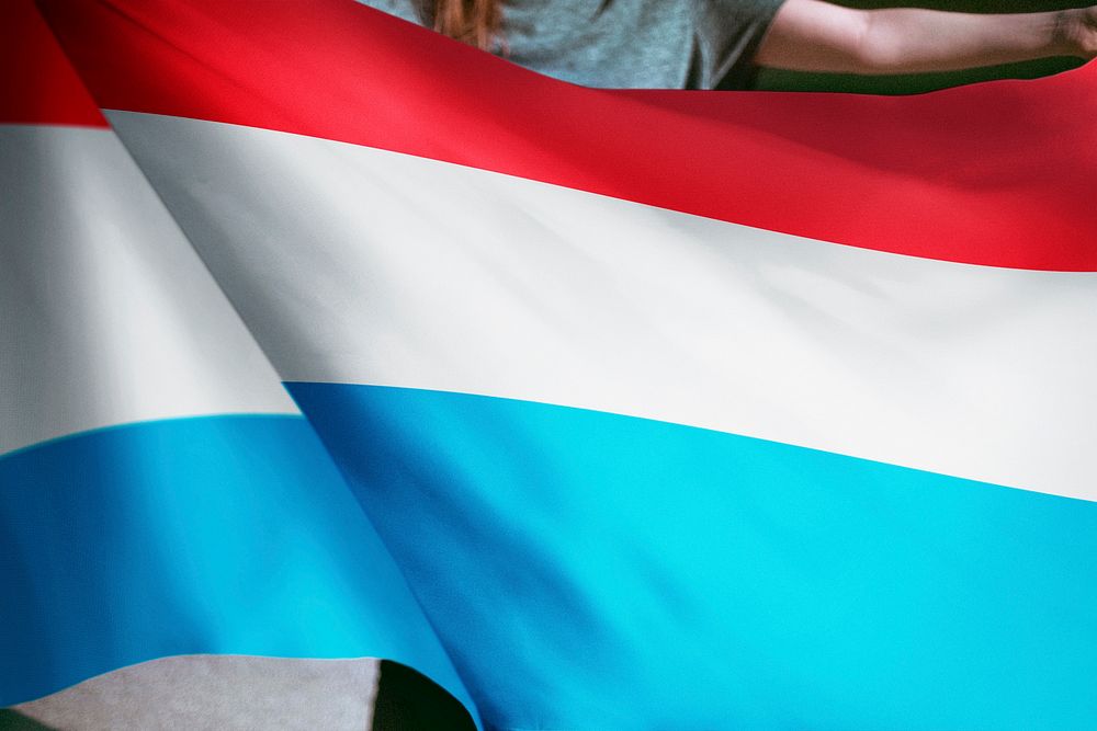 Person holding Luxembourg flag background, national symbol