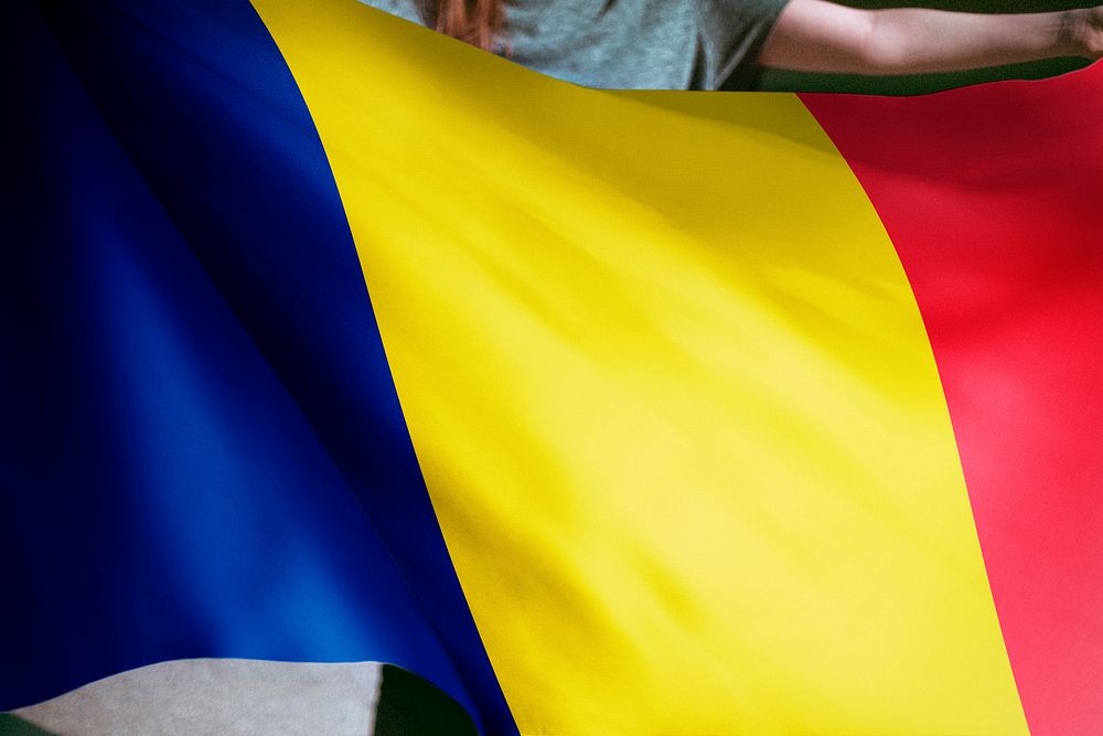 Person holding Chad flag background, national symbol