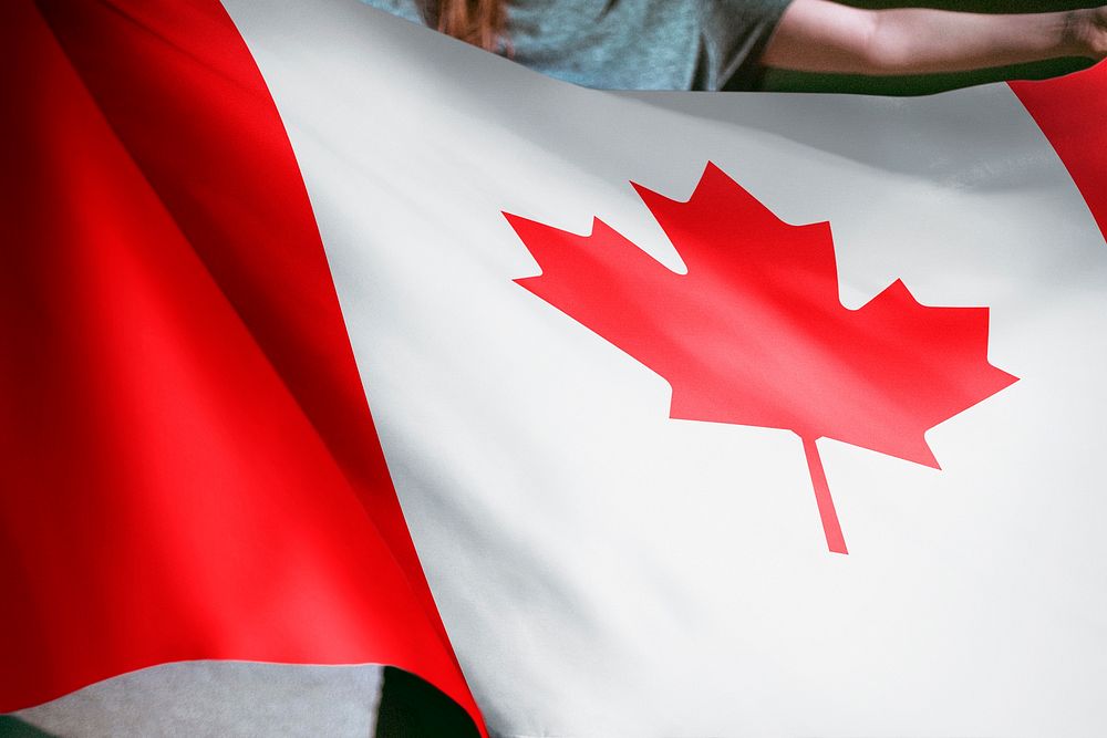 Person holding Canadian flag background, national symbol