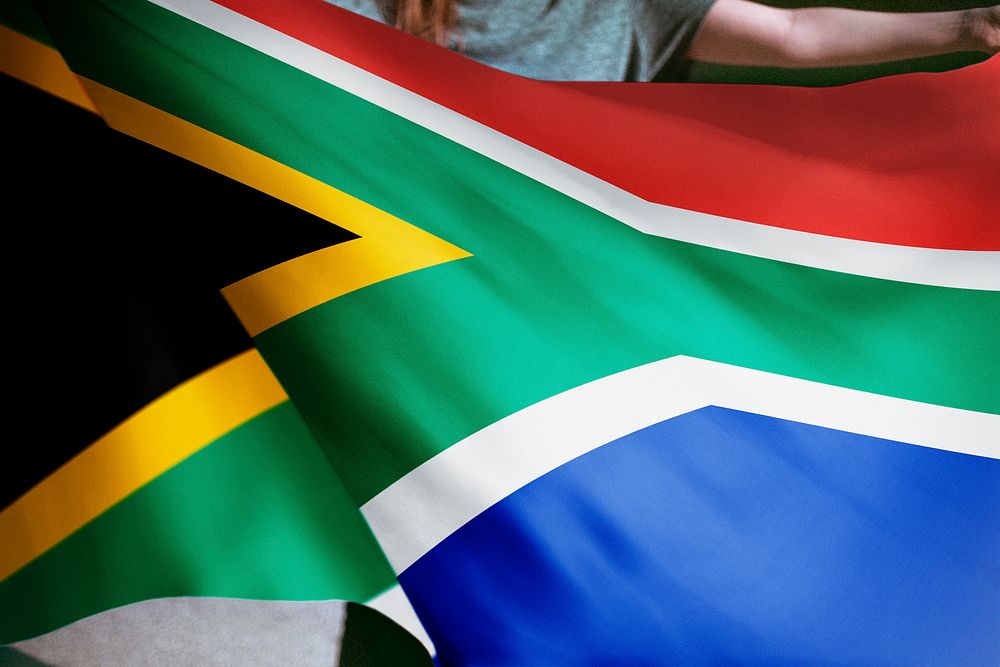 Person holding South African flag background, national symbol