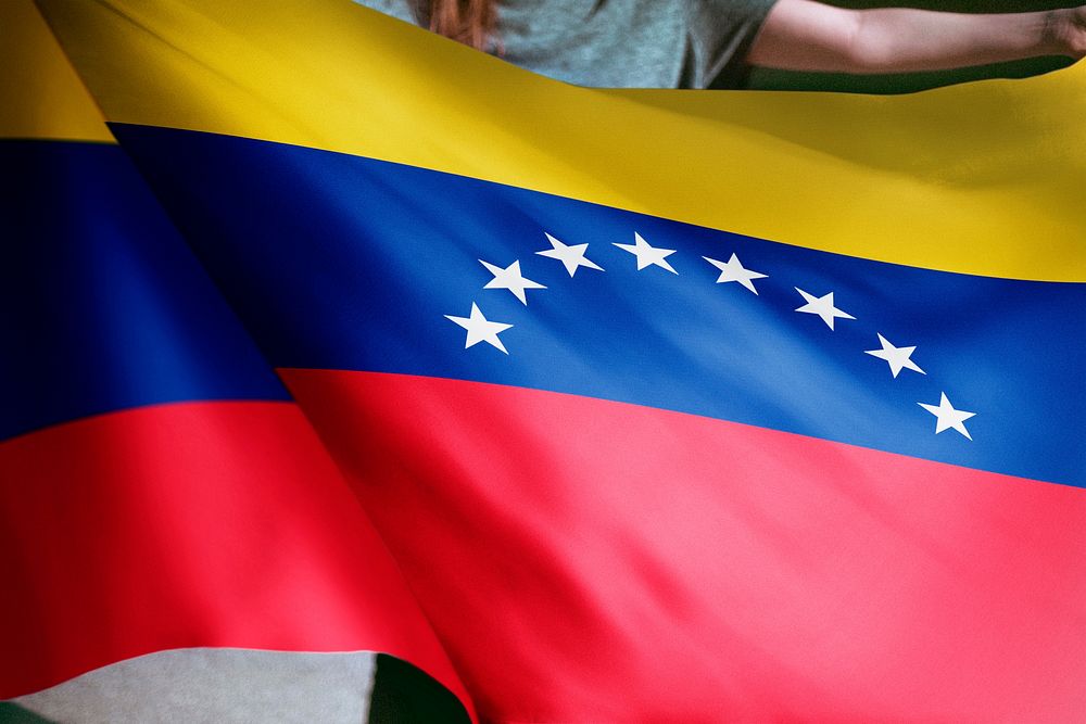 Person holding Venezuela flag background, national symbol