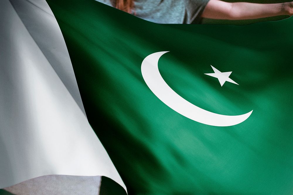 Person holding Pakistani flag background, national symbol