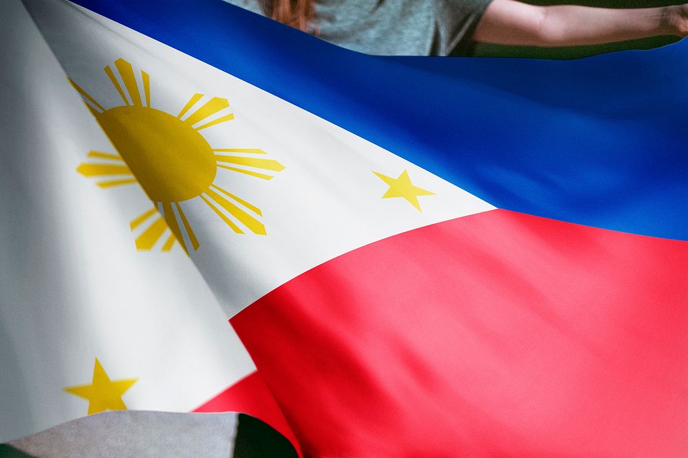 Person holding Philippines flag background, national symbol