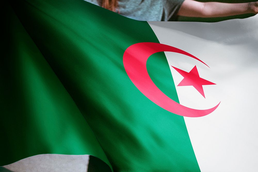 Person holding Algeria flag background, national symbol