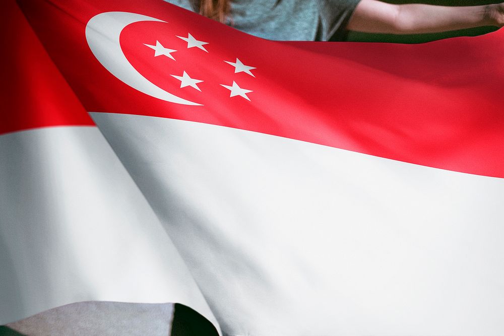 Person holding Singaporean flag background, national symbol