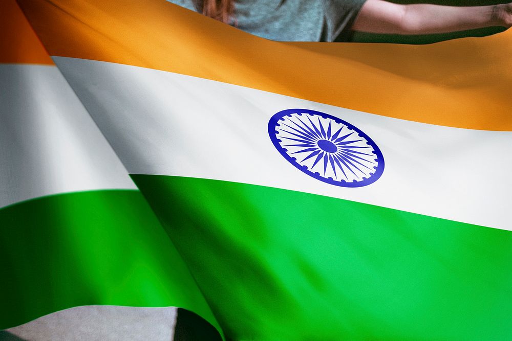 Person holding Indian flag background, national symbol