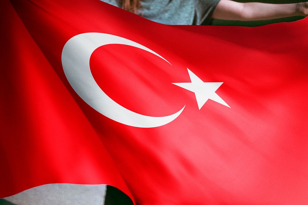 Person holding Turkey flag background, national symbol