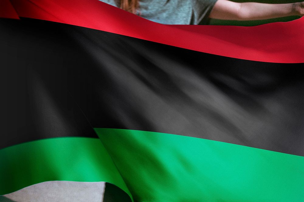 Person holding Pan-African flag background, national symbol