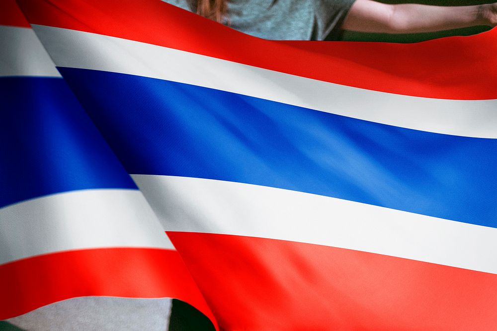 Person holding Thai flag background, national symbol